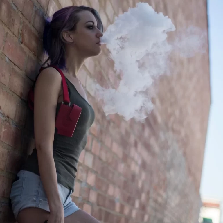 woman uses disposable vape