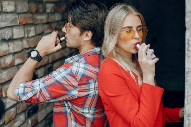 stylish young couple with vape city