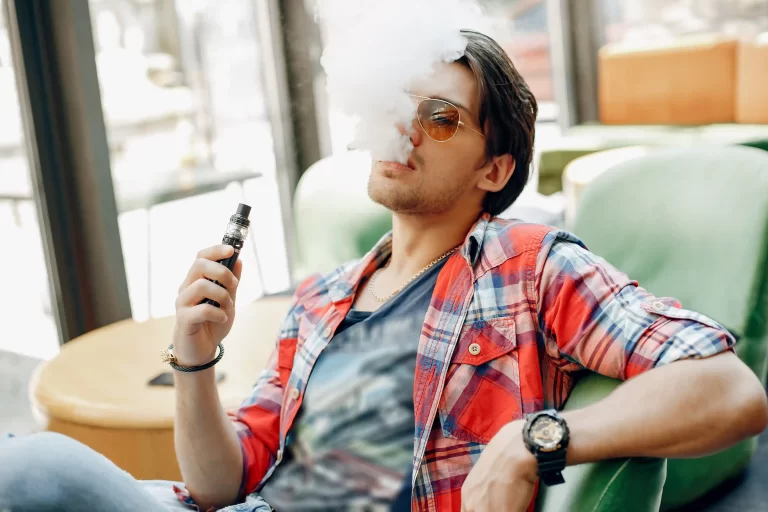 1 stylish-elegant-man-sitting-cafe-with-vape